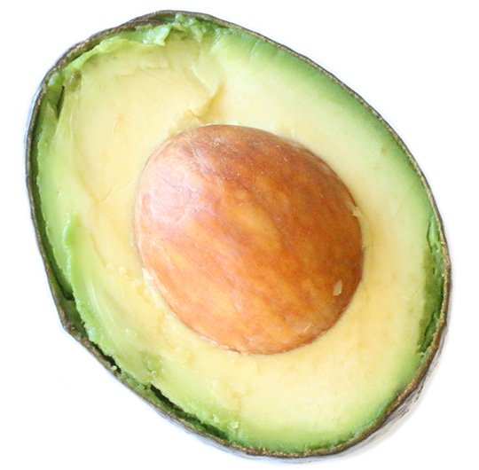 A bright green, halved avocado placed over a white background.
